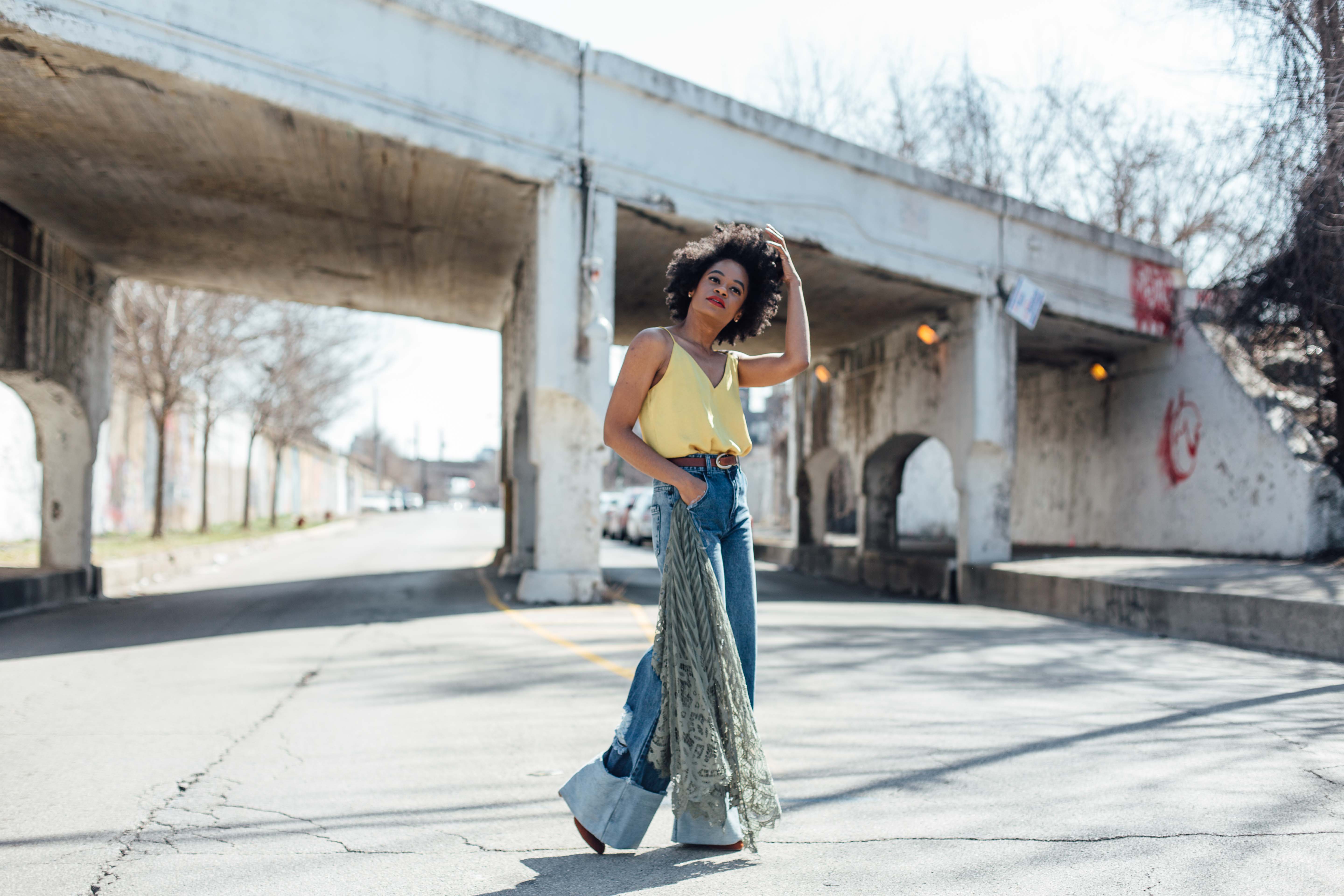 Wide leg denim jeans and gold tank